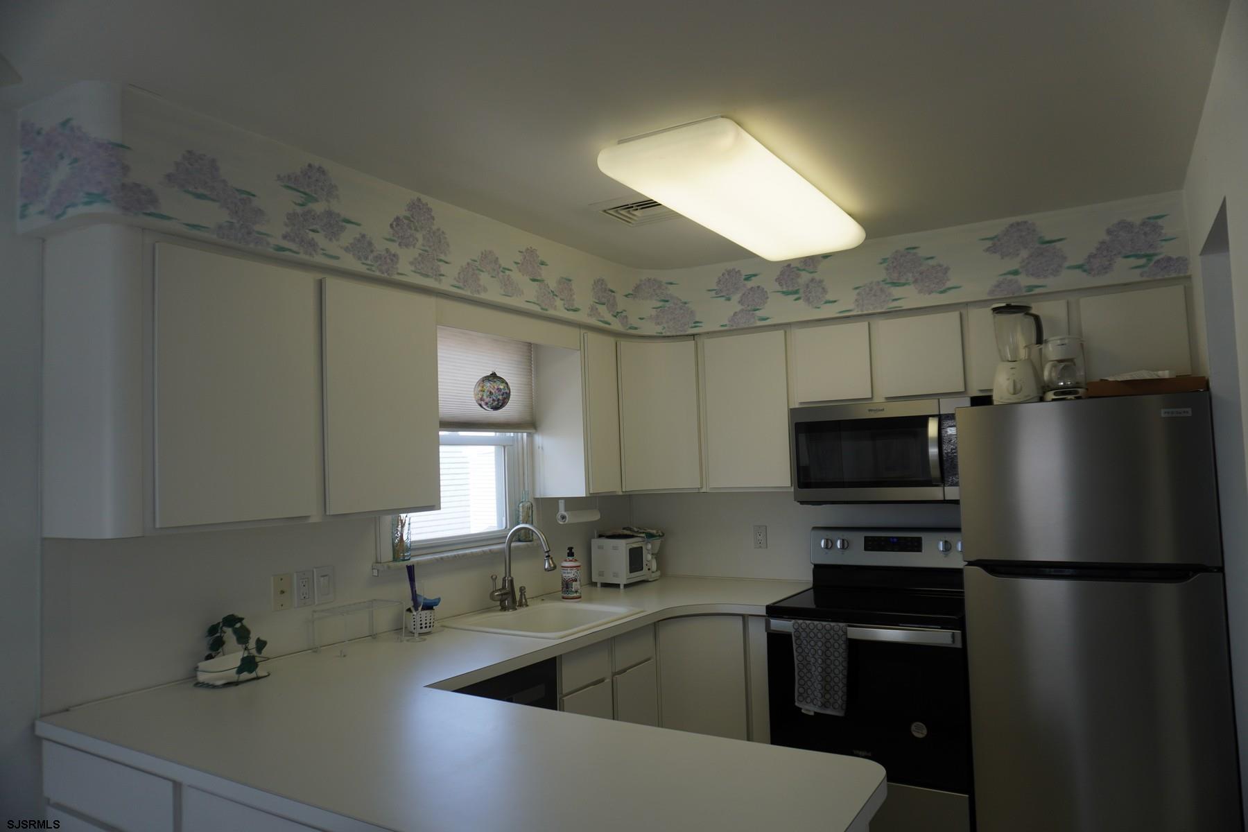 15 South Decatur Avenue, Unit B Margate City, NJ 08402 - Photo 15 of 27 a kitchen with a sink stainless steel appliances and cabinets