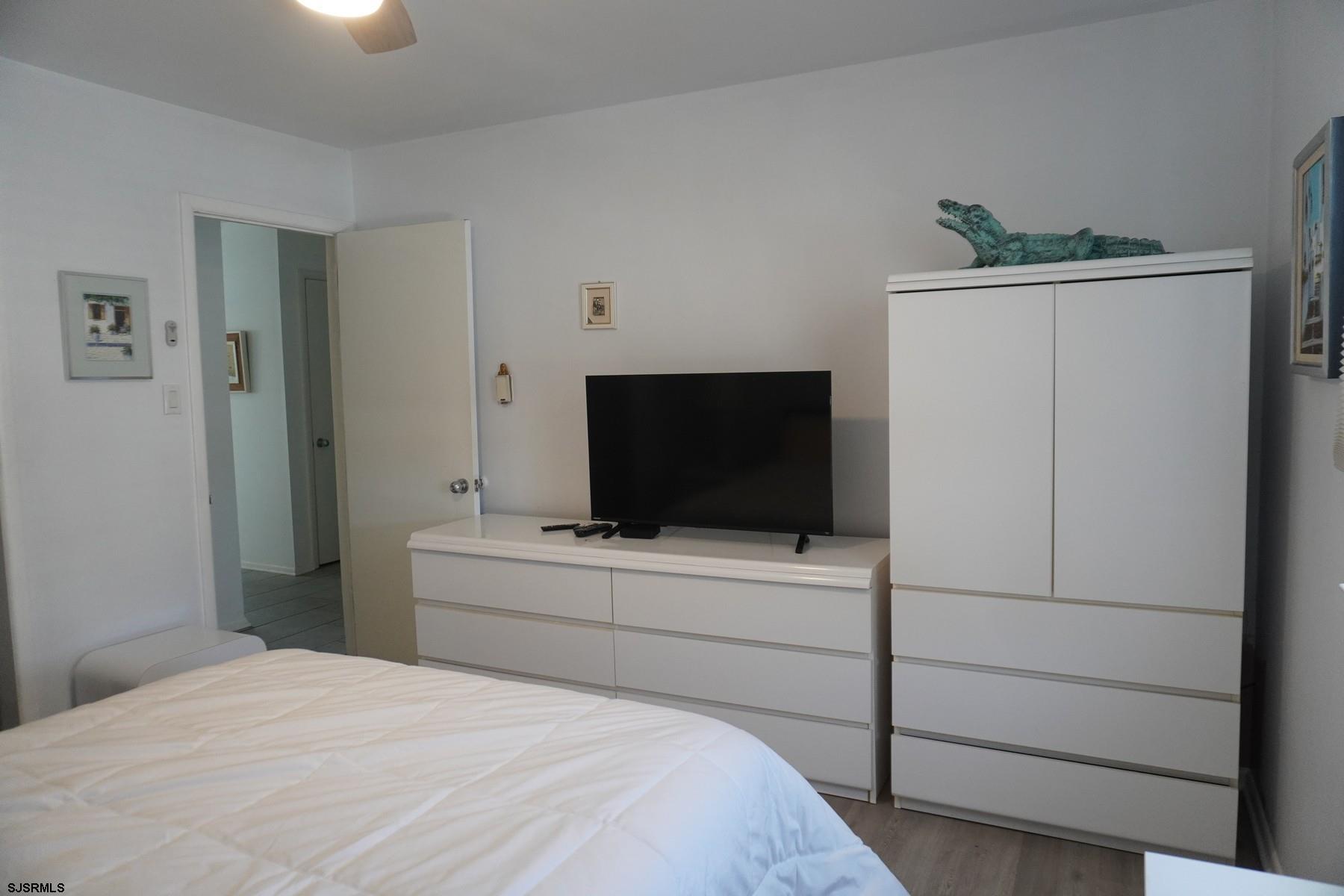 15 South Decatur Avenue, Unit B Margate City, NJ 08402 - Photo 22 of 27 a bedroom with a bed and a flat screen tv
