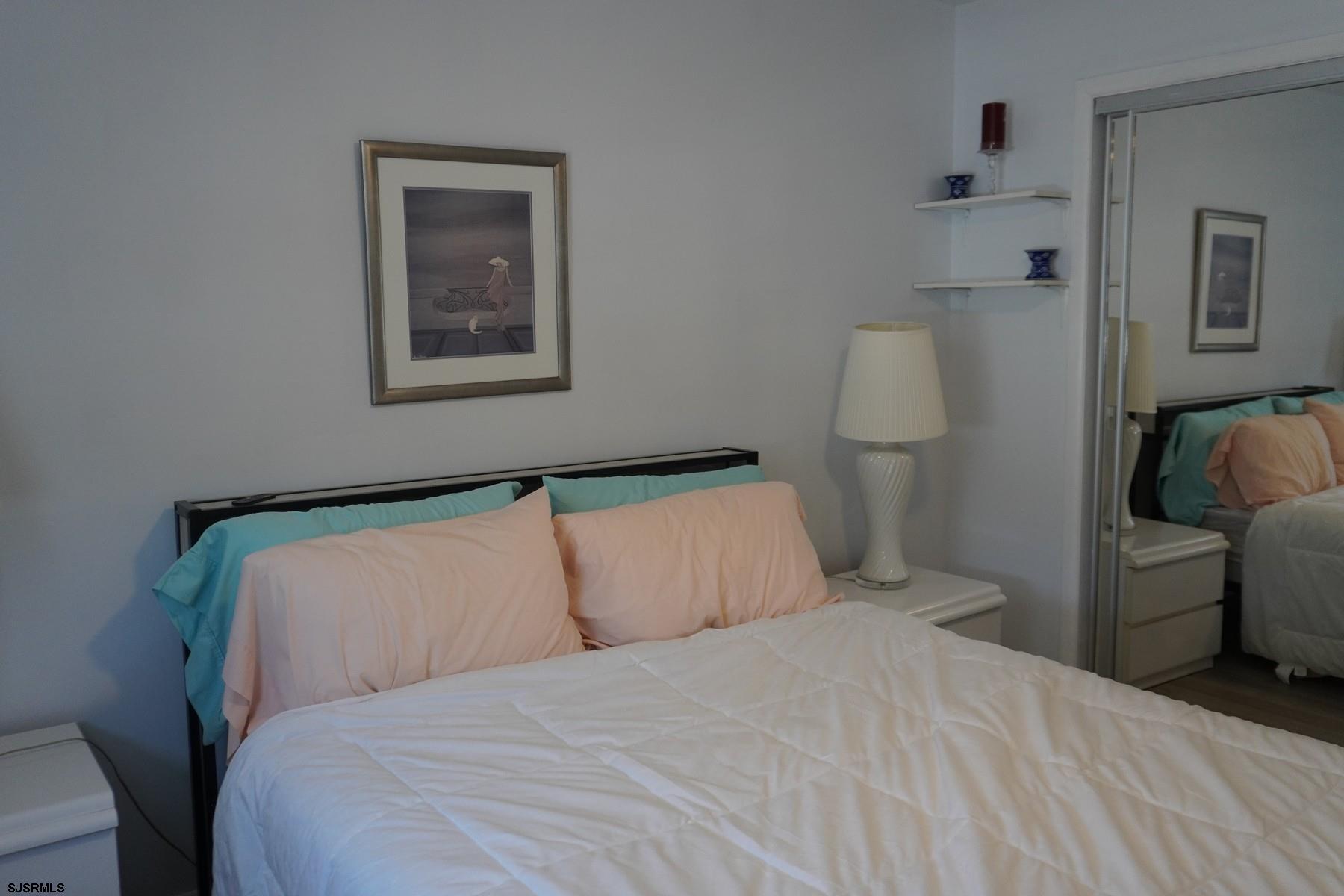 15 South Decatur Avenue, Unit B Margate City, NJ 08402 - Photo 23 of 27 a bedroom with a bed and a painting on the wall