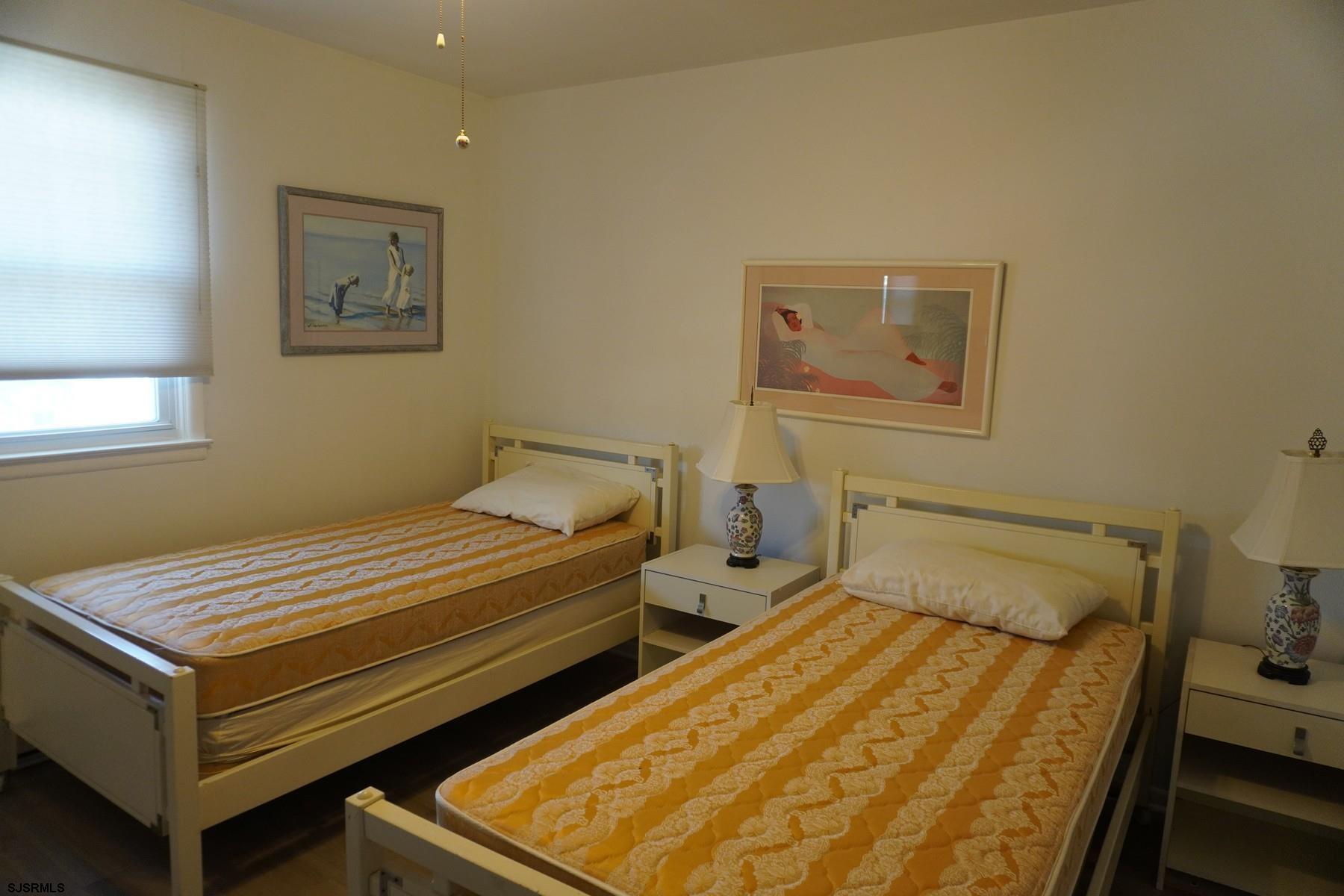 15 South Decatur Avenue, Unit B Margate City, NJ 08402 - Photo 26 of 27 a bedroom with a bed and wooden floor