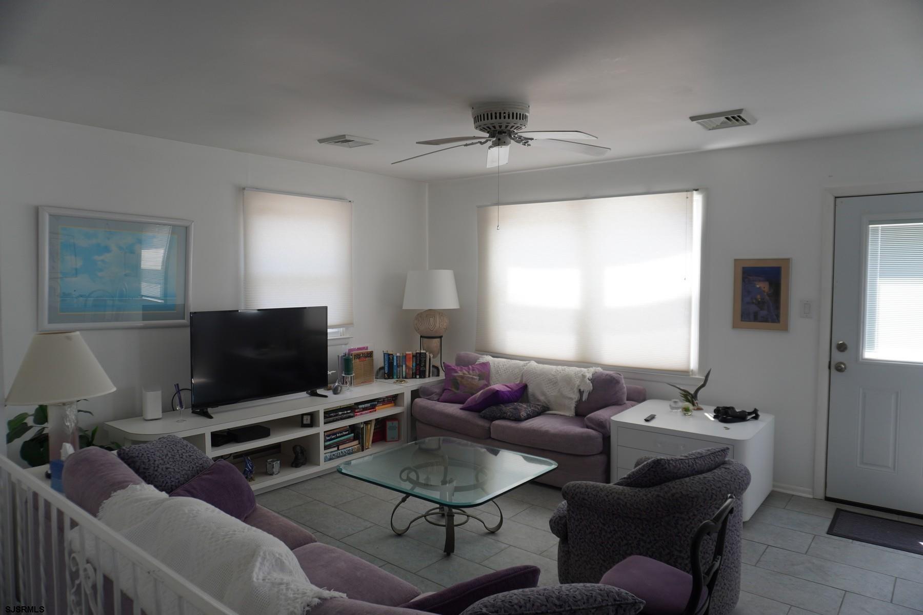 15 South Decatur Avenue, Unit B Margate City, NJ 08402 - Photo 7 of 27 a living room with furniture and a flat screen tv