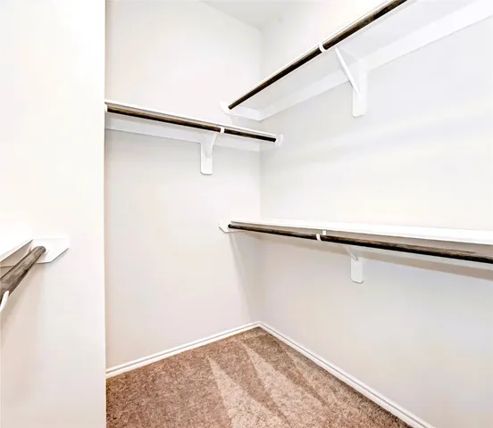 a bathroom with a bathtub a double vanity sink and a mirror