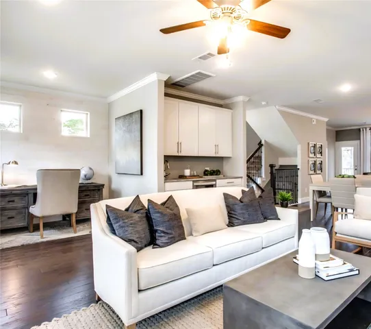 a living room with furniture white walls and a chandelier