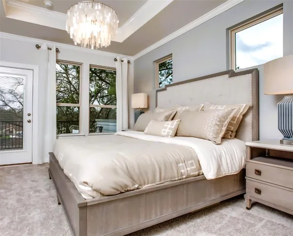 a bed sitting in a spacious bedroom next to a window