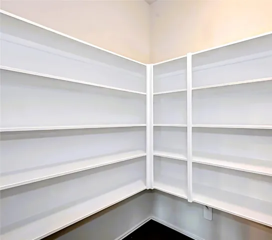 a kitchen with granite countertop a stove and a sink wooden floor