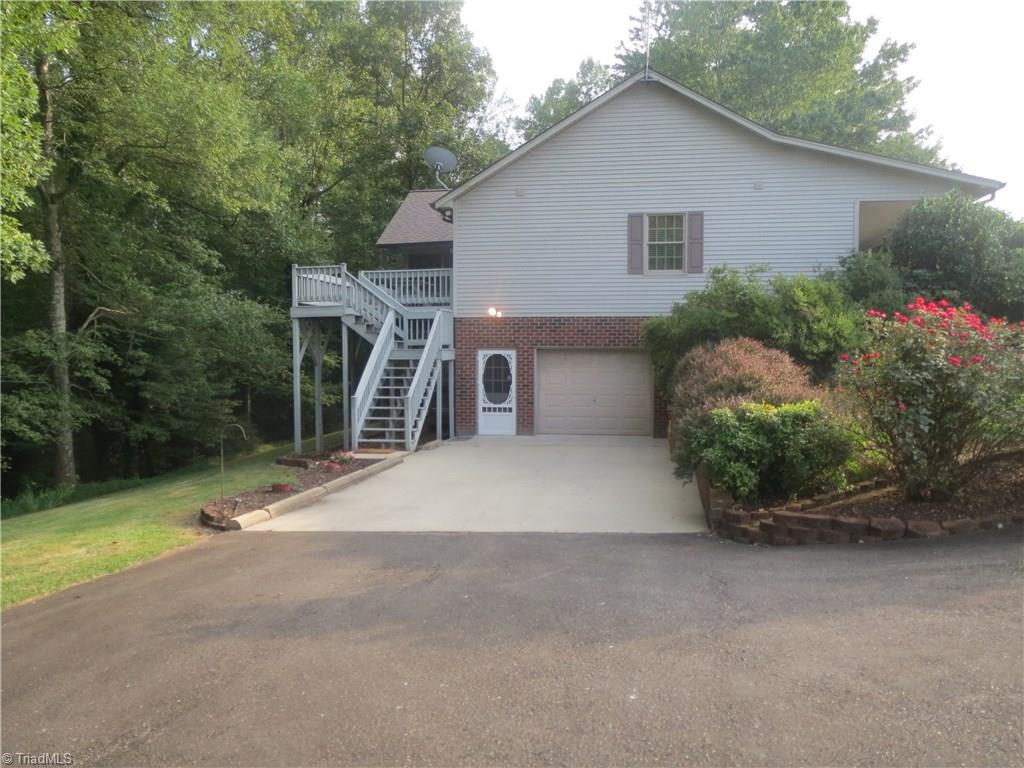 953 Hodges Mill Road Dobson, NC 27017 - Photo 4 of 29 Large paved drive with basement garage and steps to deck.