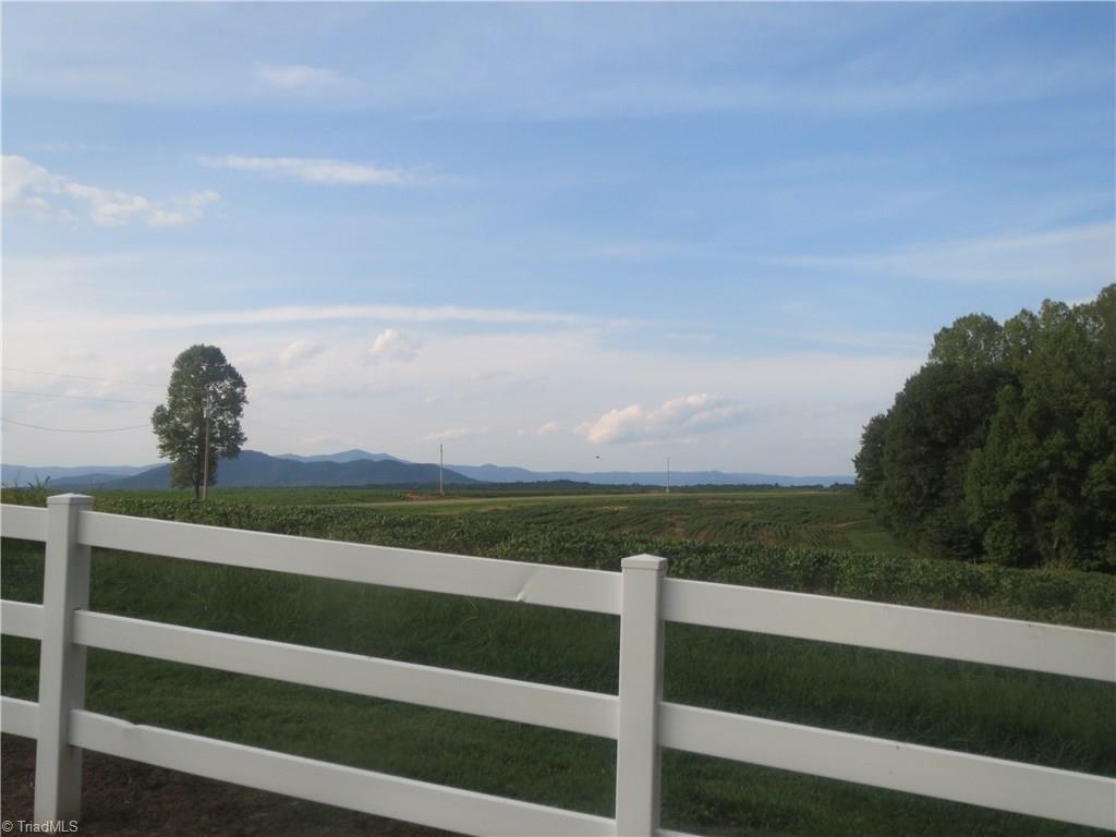 953 Hodges Mill Road Dobson, NC 27017 - Photo 6 of 29 Property features white fencing and mountain views.