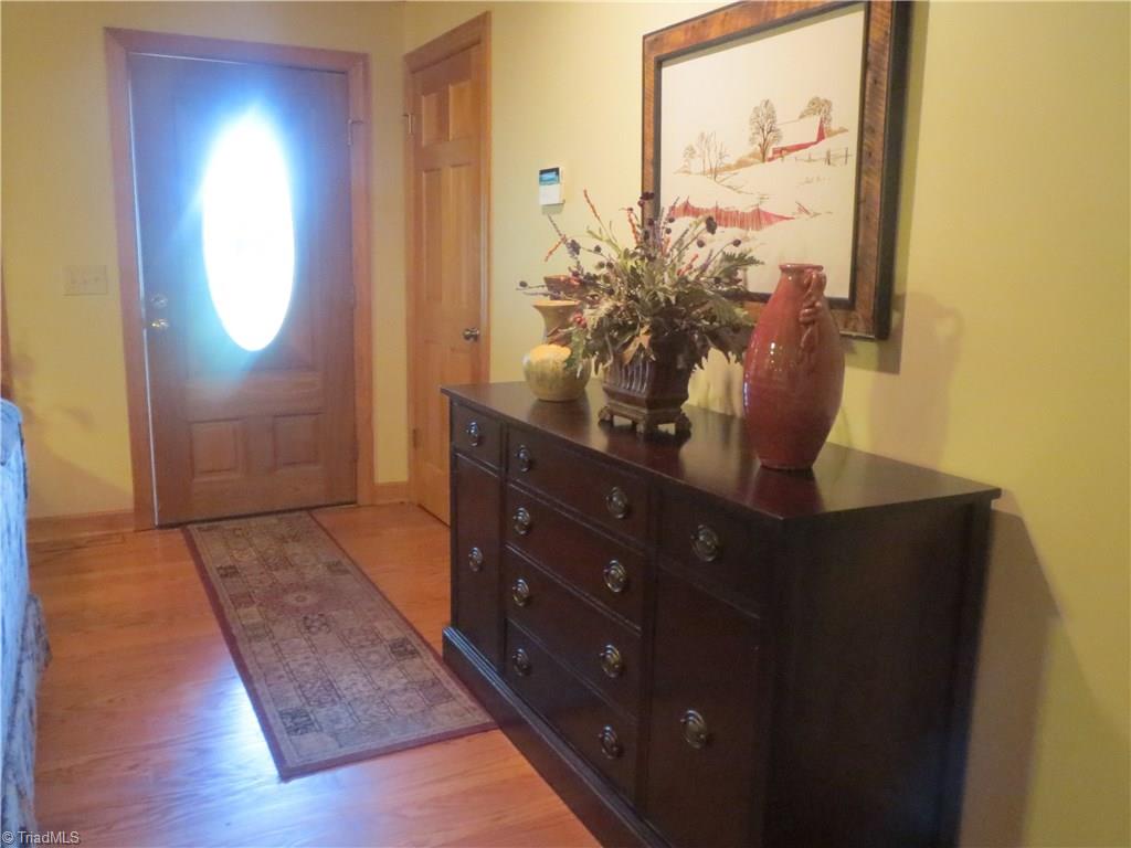 953 Hodges Mill Road Dobson, NC 27017 - Photo 8 of 29 Foyer with hardwood floors and view of lead glass front door.
