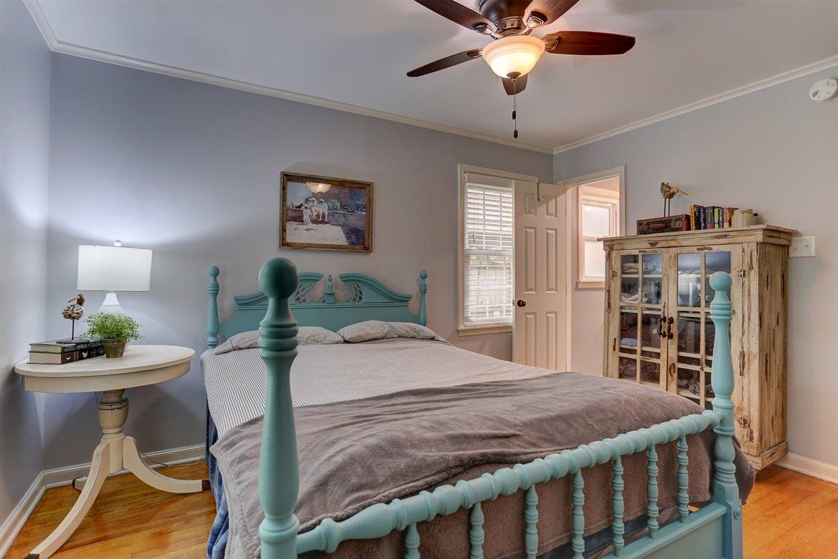 1611 Ivy Road Memphis, TN 38117 - Photo 20 of 29 a bedroom with a bed and a chandelier