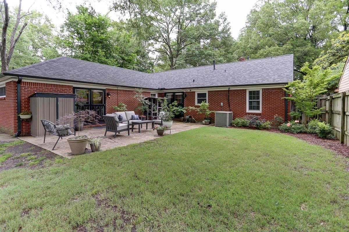 1611 Ivy Road Memphis, TN 38117 - Photo 29 of 29 a view of a patio with table and chairs potted plants and large tree