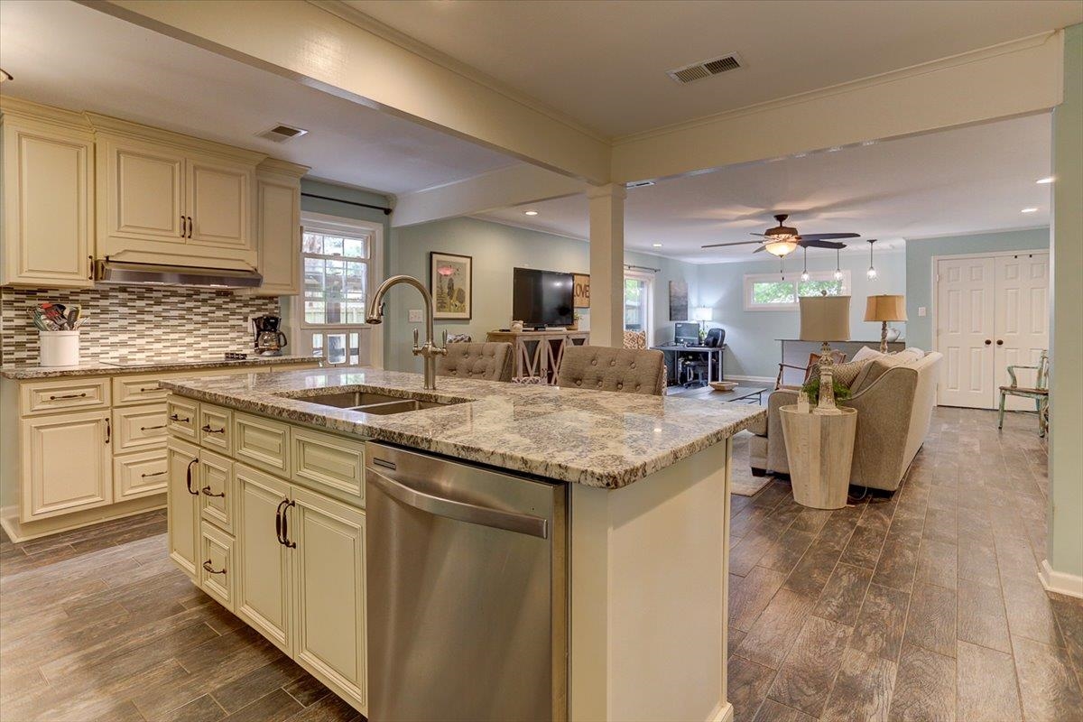 1611 Ivy Road Memphis, TN 38117 - Photo 6 of 29 a kitchen with granite countertop a sink and white cabinets