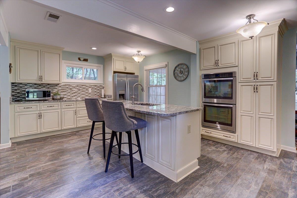 1611 Ivy Road Memphis, TN 38117 - Photo 8 of 29 a kitchen with granite countertop a table chairs microwave and cabinets