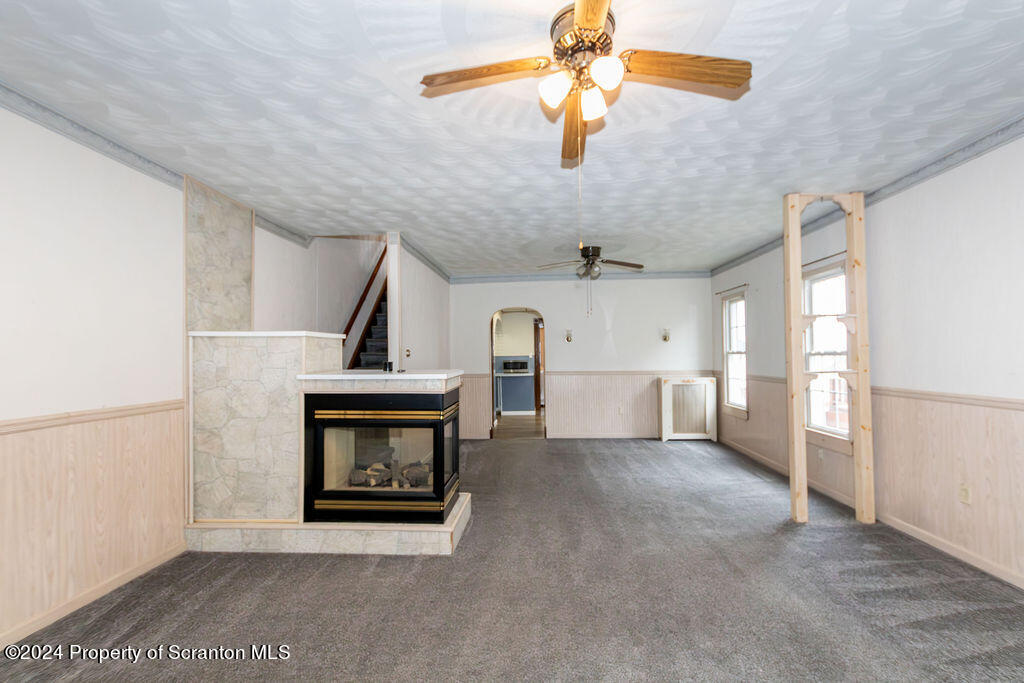 1148 West Locust Street Scranton, PA 18504 - Photo 11 of 40 a view of an empty room with chandelier fan and fire place