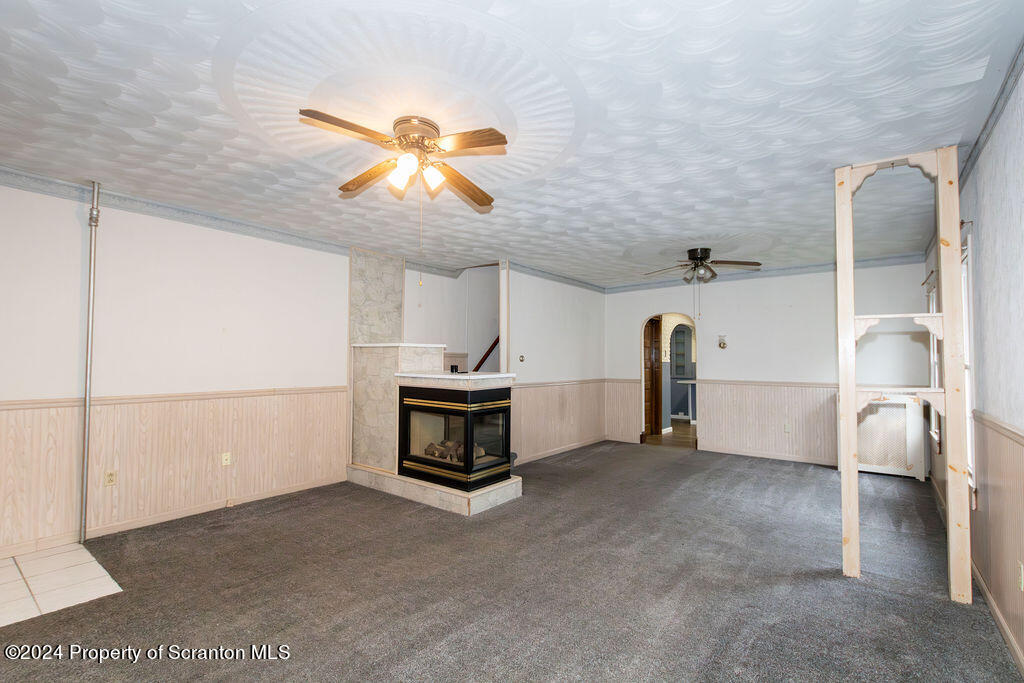 1148 West Locust Street Scranton, PA 18504 - Photo 14 of 40 a view of a livingroom with a ceiling fan and entryway
