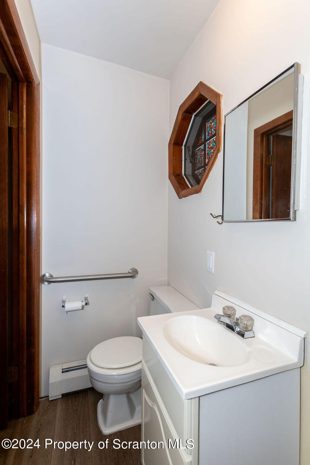 1148 West Locust Street Scranton, PA 18504 - Photo 17 of 40 a bathroom with a toilet a sink and mirror