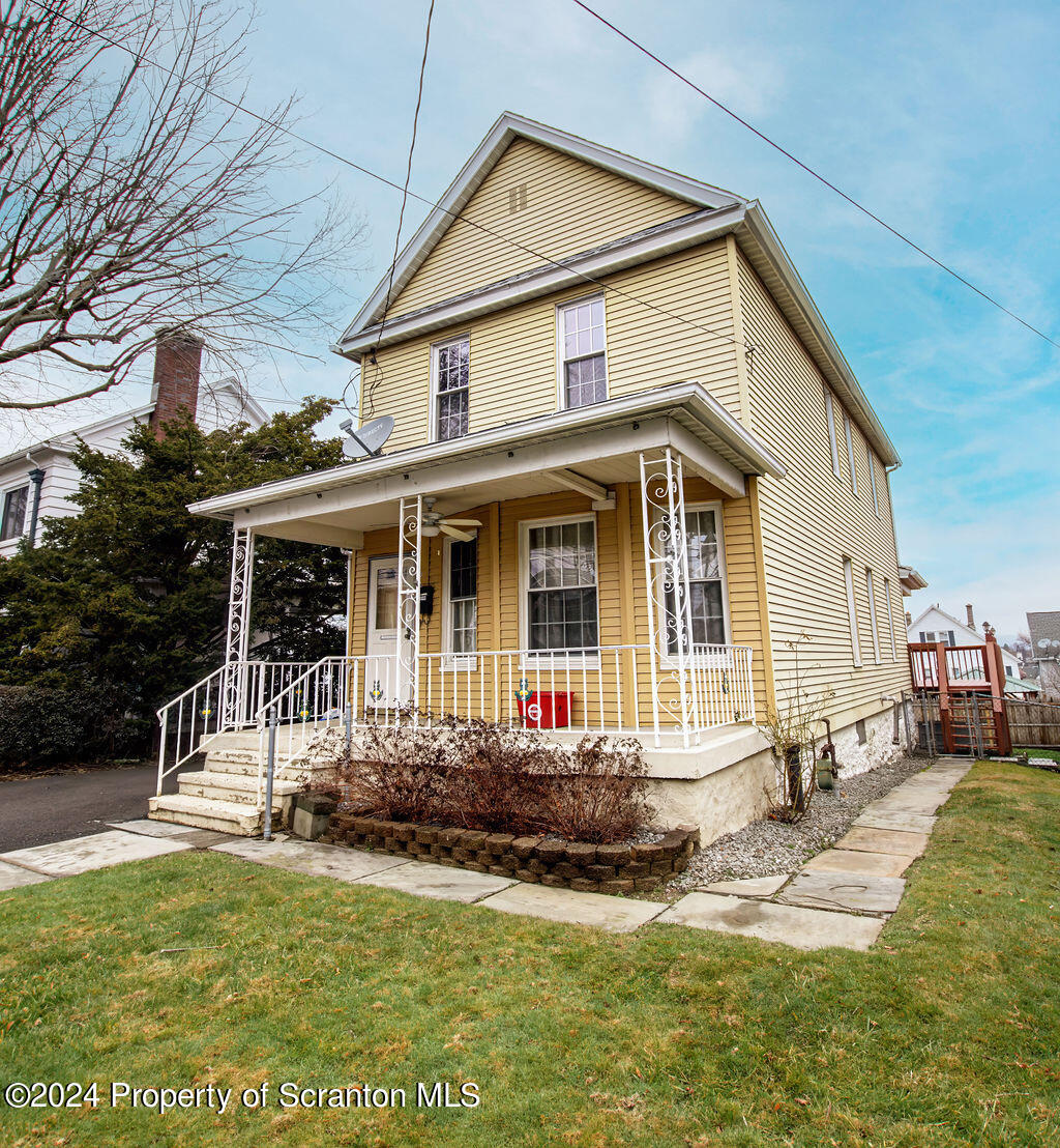 1148 West Locust Street Scranton, PA 18504 - Photo 2 of 40 a front view of a house with a yard