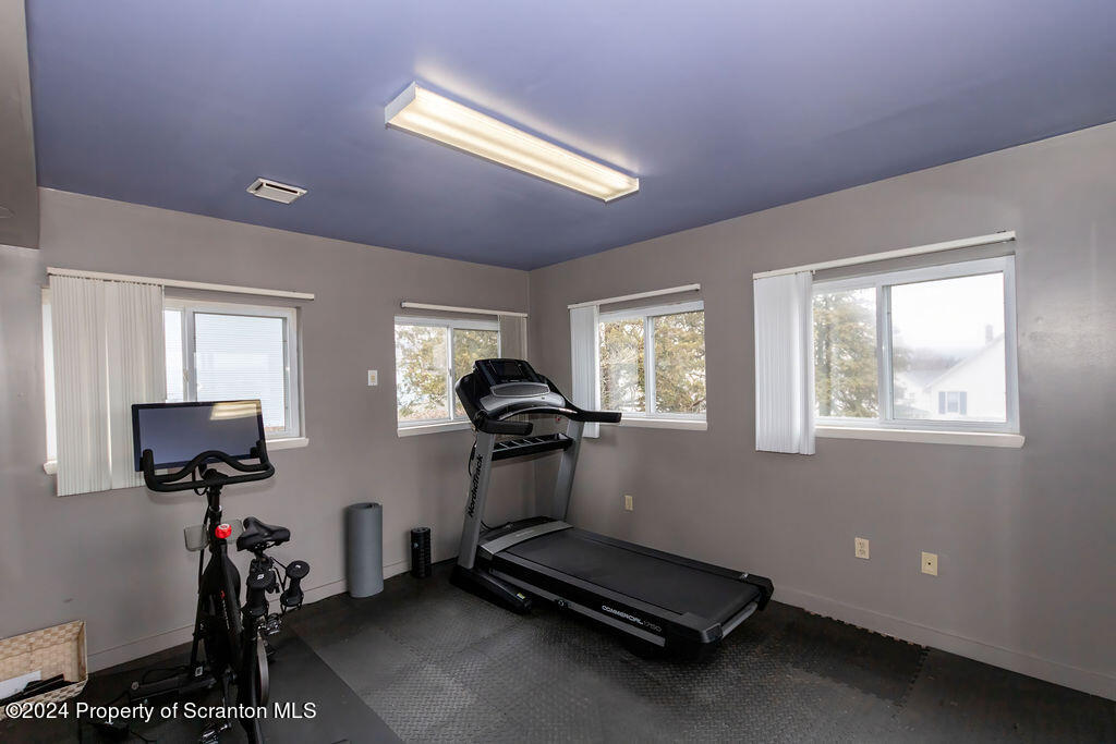 1148 West Locust Street Scranton, PA 18504 - Photo 22 of 40 a room with gym equipment and windows