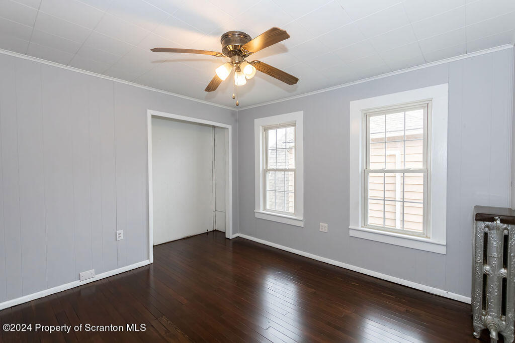 1148 West Locust Street Scranton, PA 18504 - Photo 25 of 40 a view of an empty room with wooden floor and a window