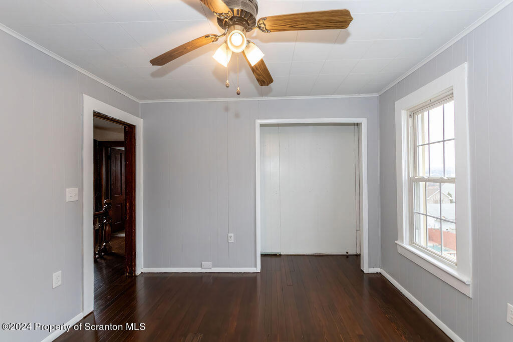 1148 West Locust Street Scranton, PA 18504 - Photo 26 of 40 a view of an empty room with wooden floor and a window
