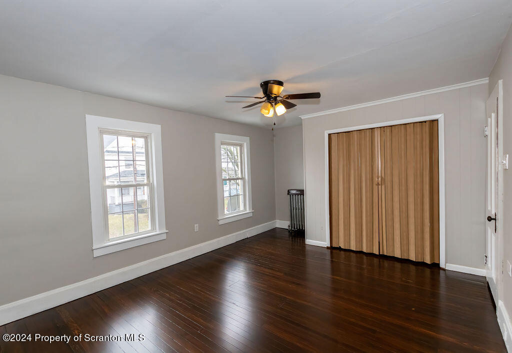 1148 West Locust Street Scranton, PA 18504 - Photo 28 of 40 an empty room with wooden floor and windows