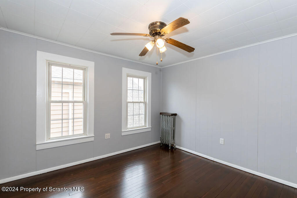 1148 West Locust Street Scranton, PA 18504 - Photo 30 of 40 a view of an empty room with wooden floor and a window