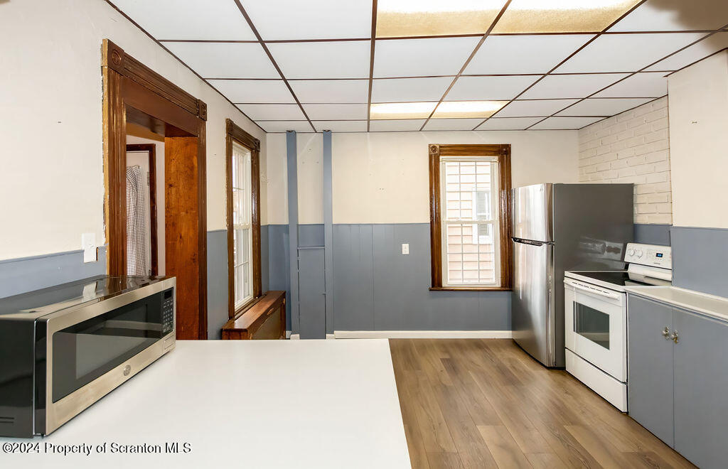 1148 West Locust Street Scranton, PA 18504 - Photo 4 of 40 a kitchen with kitchen island a counter top space appliances and a window