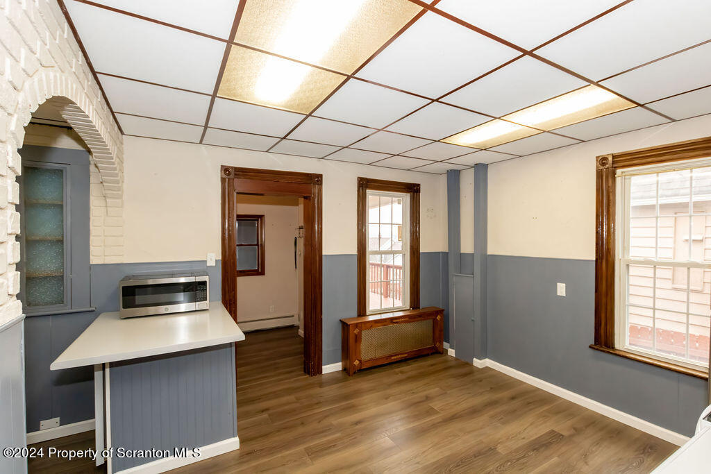 1148 West Locust Street Scranton, PA 18504 - Photo 6 of 40 a room with wooden floor and furniture