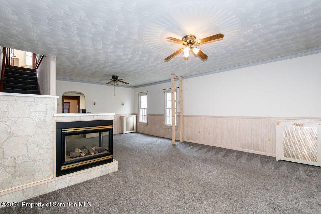1148 West Locust Street Scranton, PA 18504 - Photo 10 of 40 a view of an empty room with a fireplace and a window