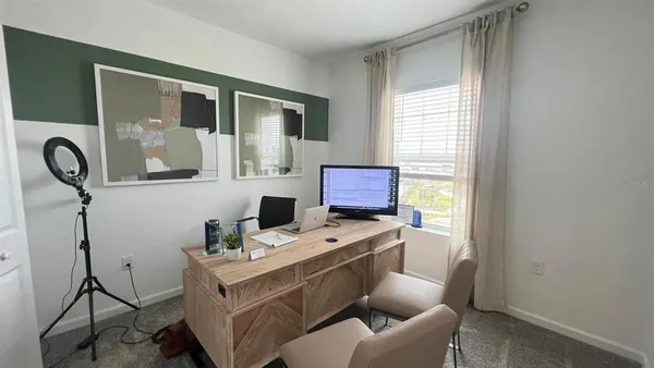 a room with furniture a flat screen tv and a window