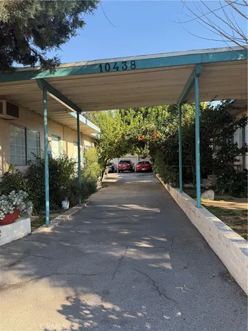 a view of backyard with a table and chairs under an umbrella