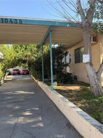 a view of a patio with a table and chairs under an umbrella