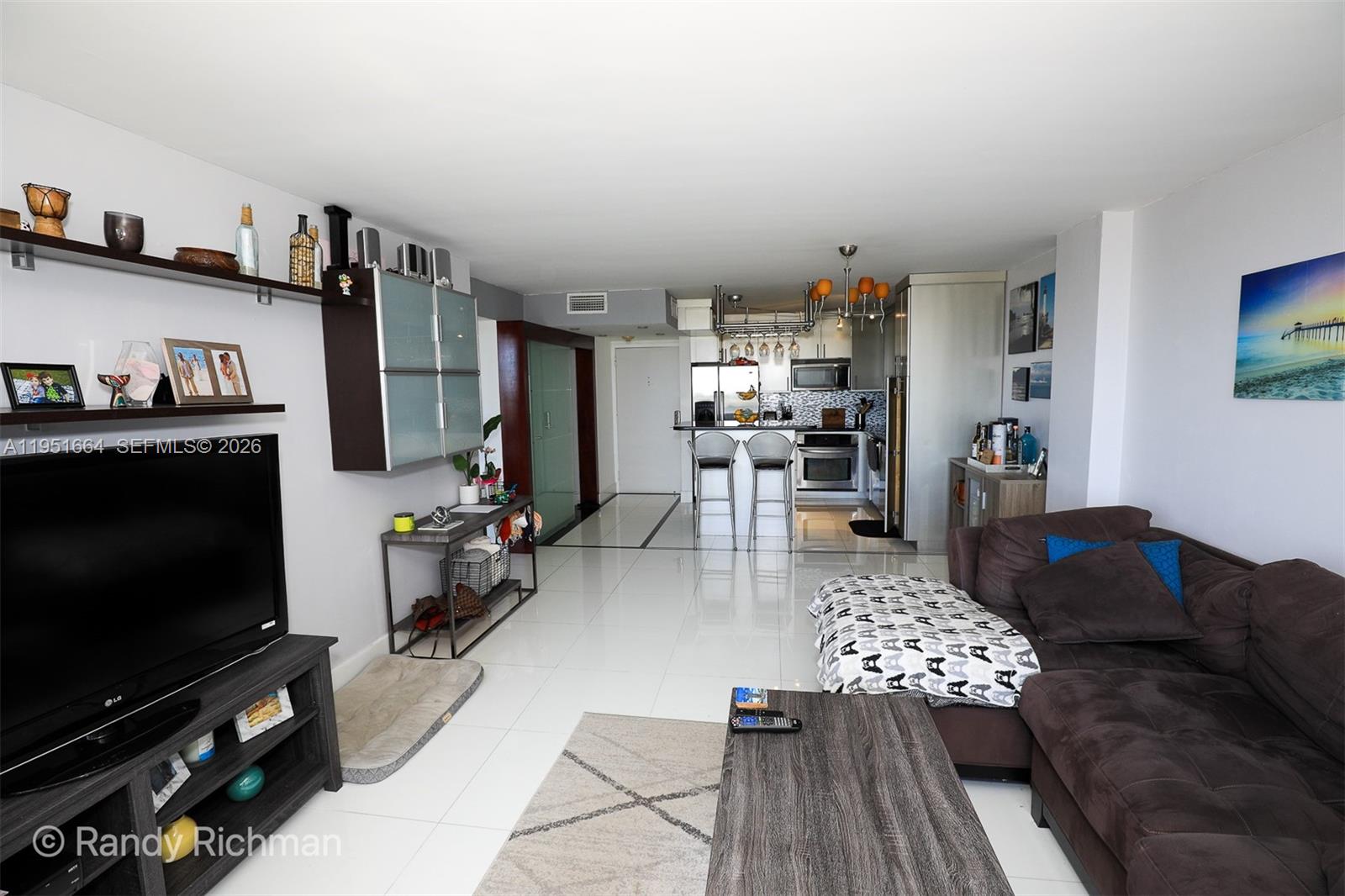 600 Northeast 36th Street, Unit 514 Miami, FL 33137 - Photo 12 of 27 a living room with furniture and a flat screen tv