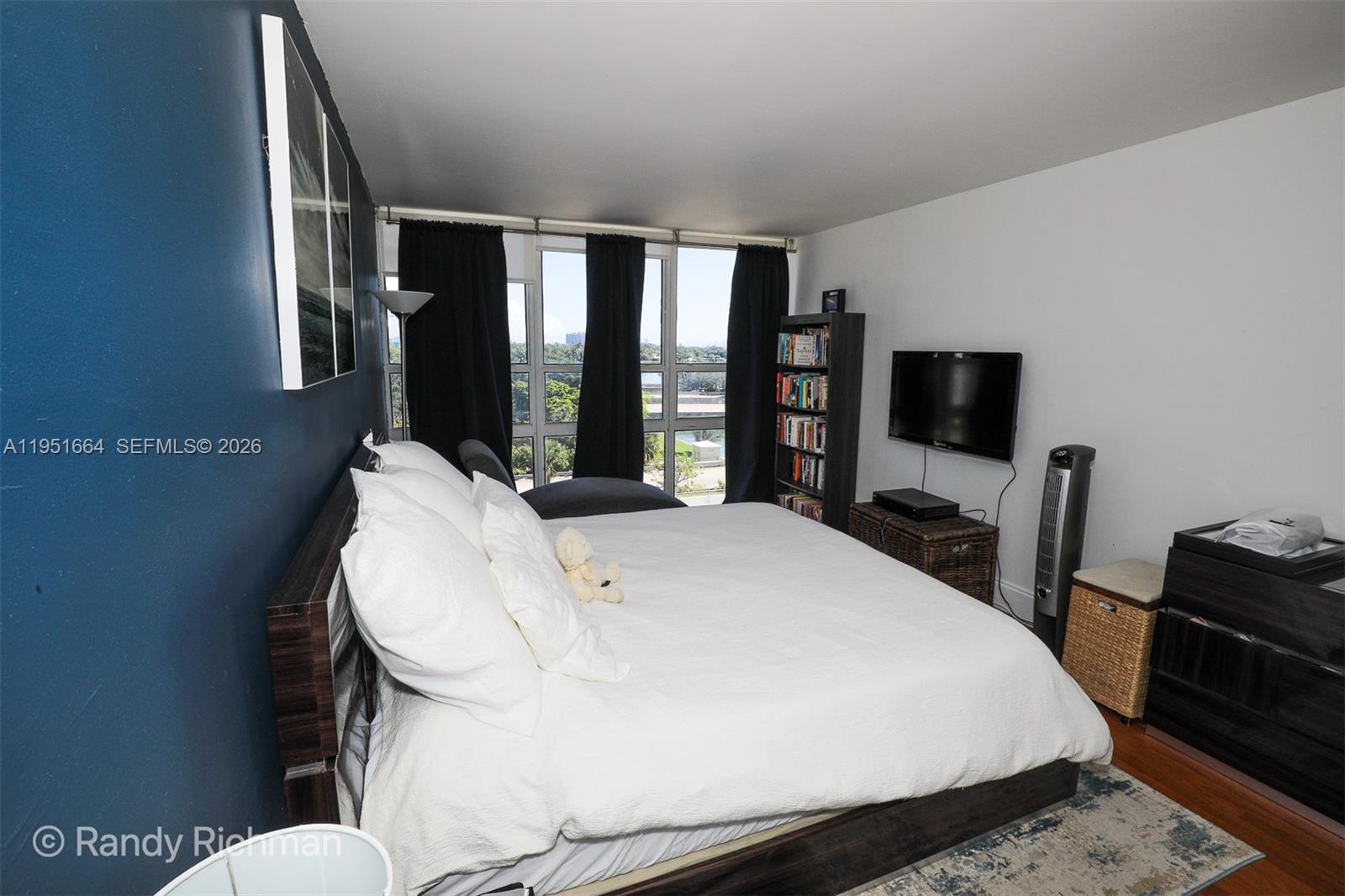 600 Northeast 36th Street, Unit 514 Miami, FL 33137 - Photo 15 of 27 a bed sitting in a bedroom next to a window with pc on the table