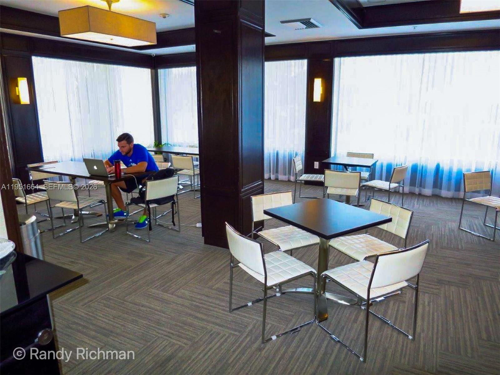 600 Northeast 36th Street, Unit 514 Miami, FL 33137 - Photo 22 of 25 a living room filled with furniture and a wooden floor