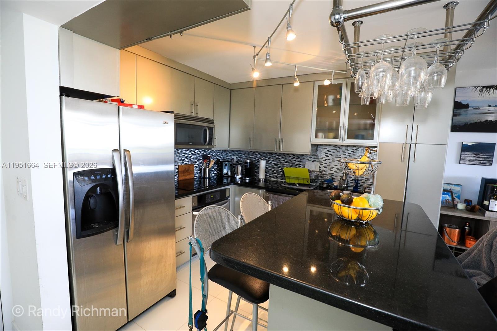600 Northeast 36th Street, Unit 514 Miami, FL 33137 - Photo 3 of 27 a kitchen with stainless steel appliances granite countertop a sink refrigerator and cabinets