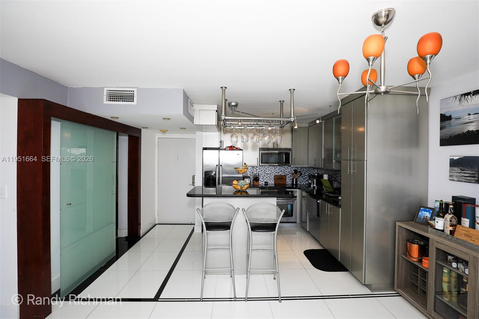 600 Northeast 36th Street, Unit 514 Miami, FL 33137 - Photo 10 of 27 a kitchen with stainless steel appliances kitchen island granite countertop a refrigerator and microwave