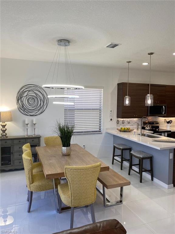8984 Madrid Circle Naples, FL 34104 - Photo 2 of 15 a view of a dining room with furniture