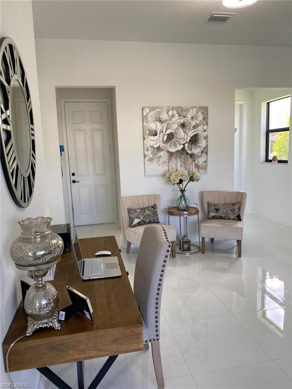 8984 Madrid Circle Naples, FL 34104 - Photo 4 of 15 a room with a table and a mirror