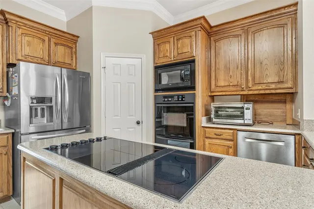 a kitchen with stainless steel appliances granite countertop a sink stove and cabinets