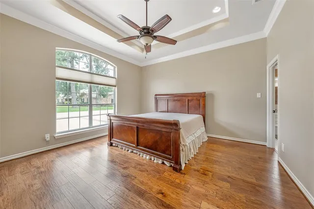 a view of an empty room with cabinet and wooden floor