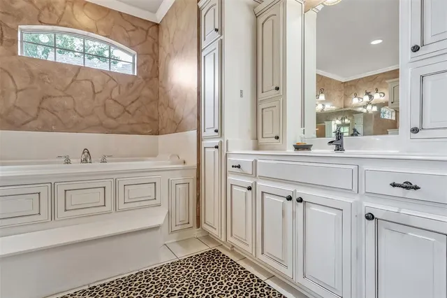 a spacious bathroom with a sink a vanity and a mirror