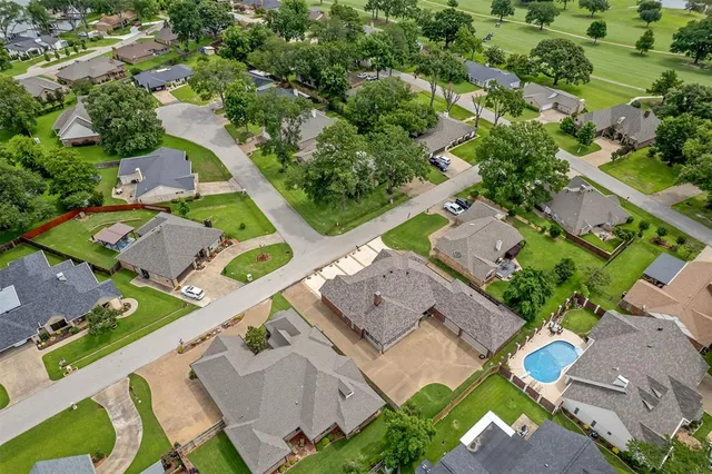 an aerial view of residential house with outdoor space and swimming pool