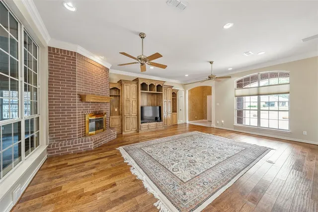 an open kitchen with sink and wooden floor