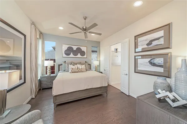 a bedroom with a bed and a painting on the wall