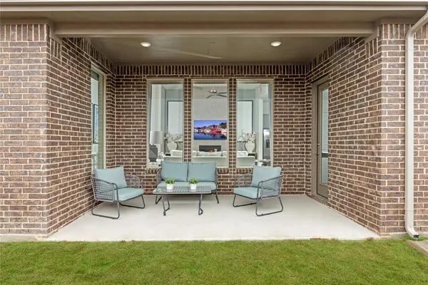 a building outdoor space with patio furniture and potted plants