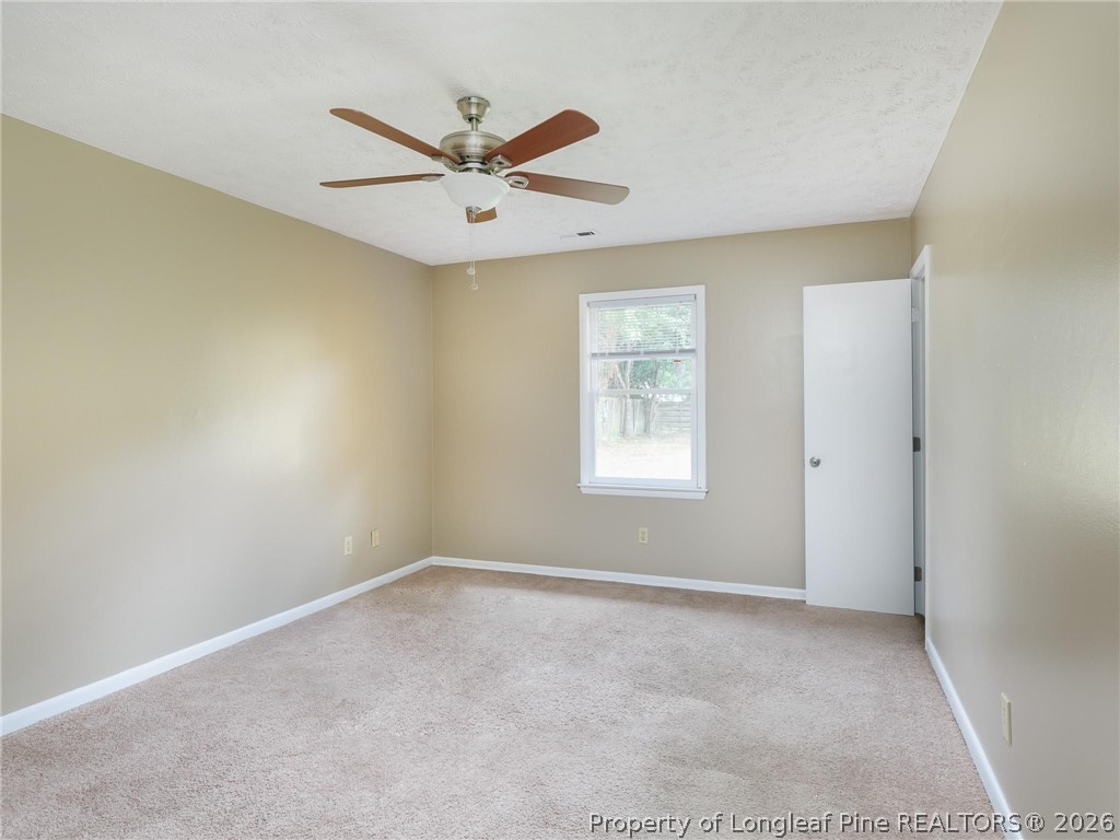 115 Eulon Loop, Unit A Raeford, NC 28376 - Photo 8 of 16 a view of a big room with a ceiling fan and windows