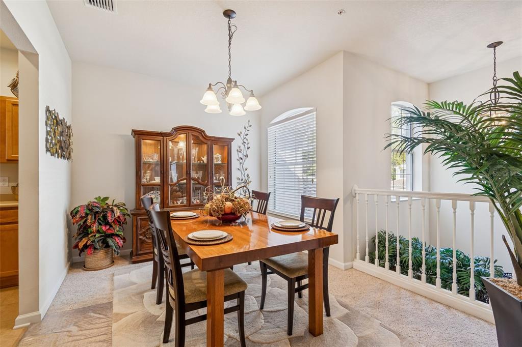 894 Lantern Way Clearwater, FL 33765 - Photo 26 of 75 a dining room with furniture a chandelier and window