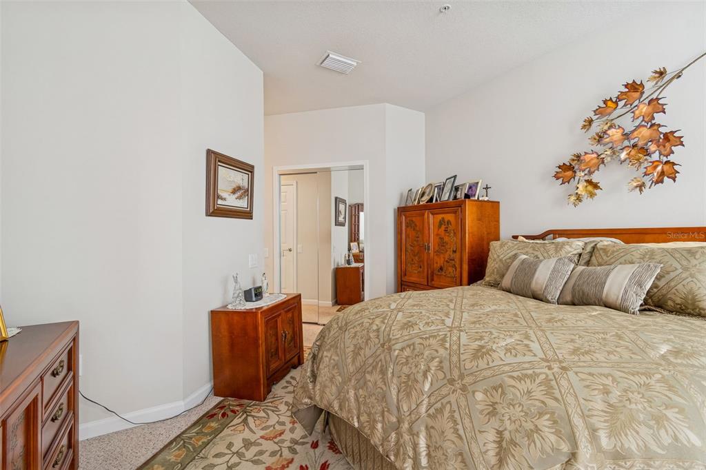 894 Lantern Way Clearwater, FL 33765 - Photo 30 of 75 a bedroom with a large bed and a couch
