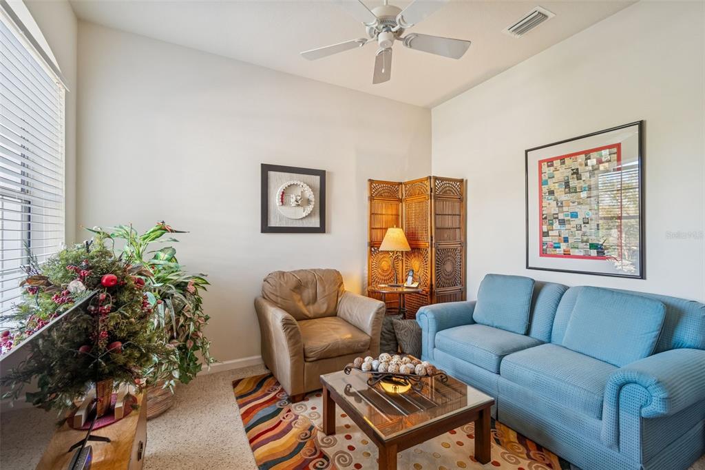 894 Lantern Way Clearwater, FL 33765 - Photo 49 of 75 a living room with furniture and flowers
