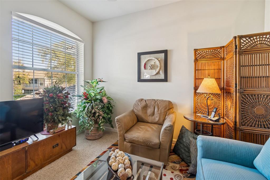 894 Lantern Way Clearwater, FL 33765 - Photo 50 of 75 a living room with furniture a flat screen tv and a window
